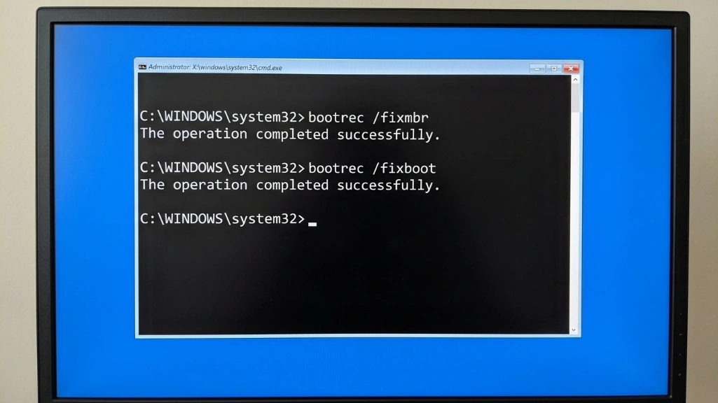 Command prompt showing successful bootrec commands for fixing SSD boot issues