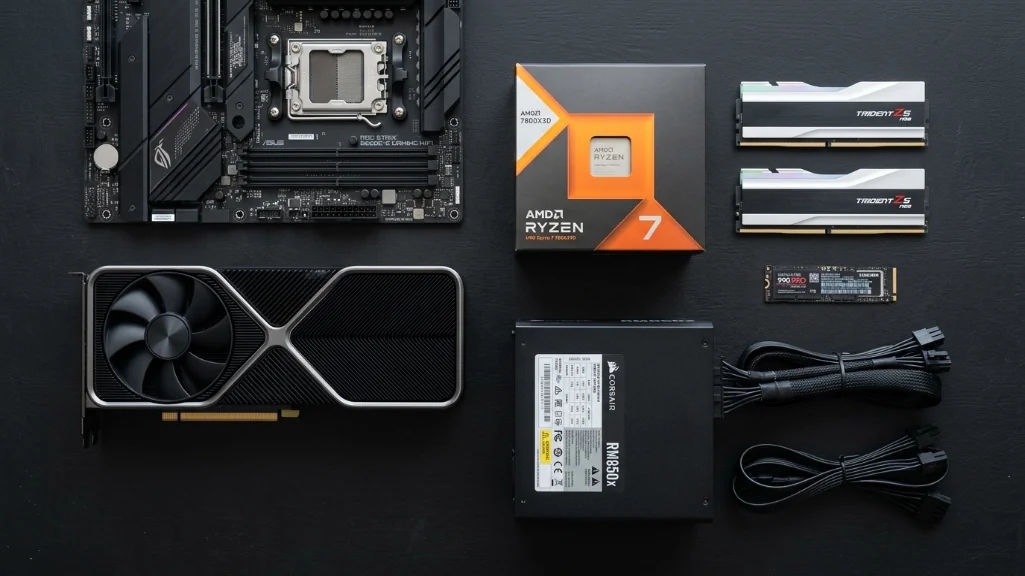 gaming PC components layout showing RTX graphics card, Ryzen processor, DDR5 RAM, NVMe SSD, and power supply on dark background