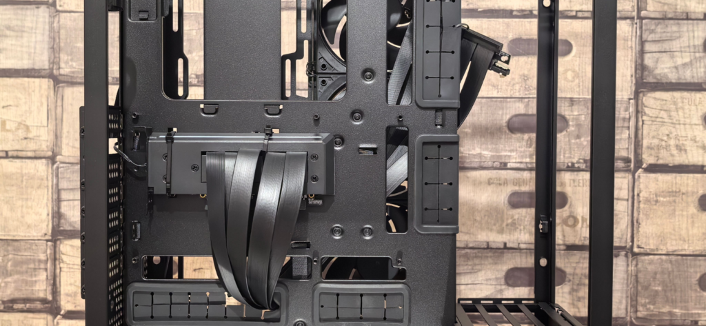 Interior of an empty PC case with cable routing channels, fan mounts and drive cages visible, ready for a build