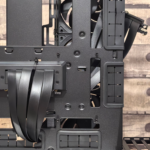 Interior of an empty PC case with cable routing channels, fan mounts and drive cages visible, ready for a build