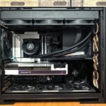 Inside a built gaming PC: a 360mm AIO radiator along the top of the case, the pump block on the CPU, a GeForce RTX graphics card below it and a row of fans across the bottom