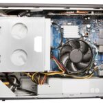 An opened branded desktop PC showing the motherboard and power supply