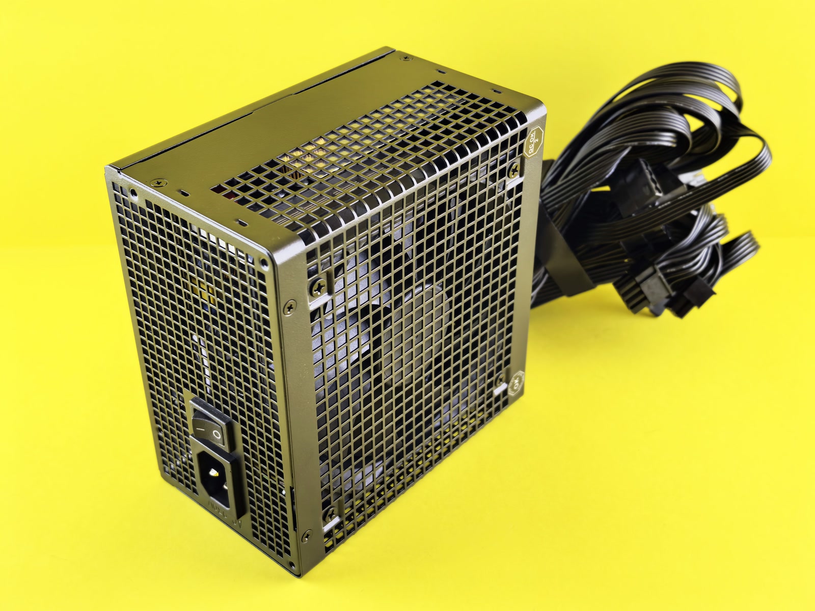 The back of a PC power supply unit with its switch and ventilation grille